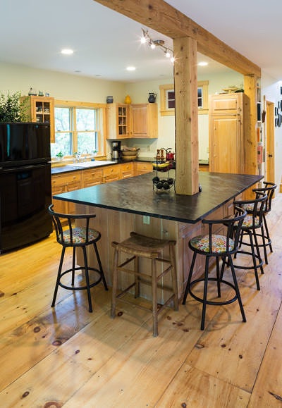Custom kitchen with stone counters in rustic saltbox in Fayston, Vermont
