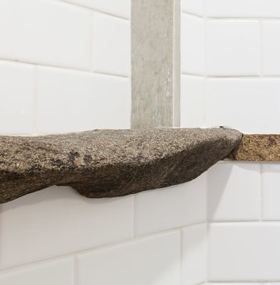 Rough stone detail in custom tiled shower in Fayston, Vermont
