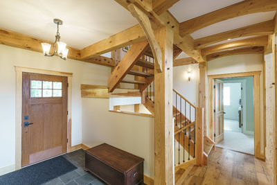 Staircase and entryway in timber frame home in Fayston, Vermont