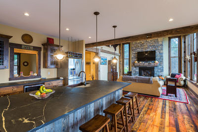 Custom kitchen and living room in western style lodge home in Waterbury, Vermont